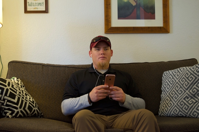 A blind man explores NFB-NEWSLINE on his phone.