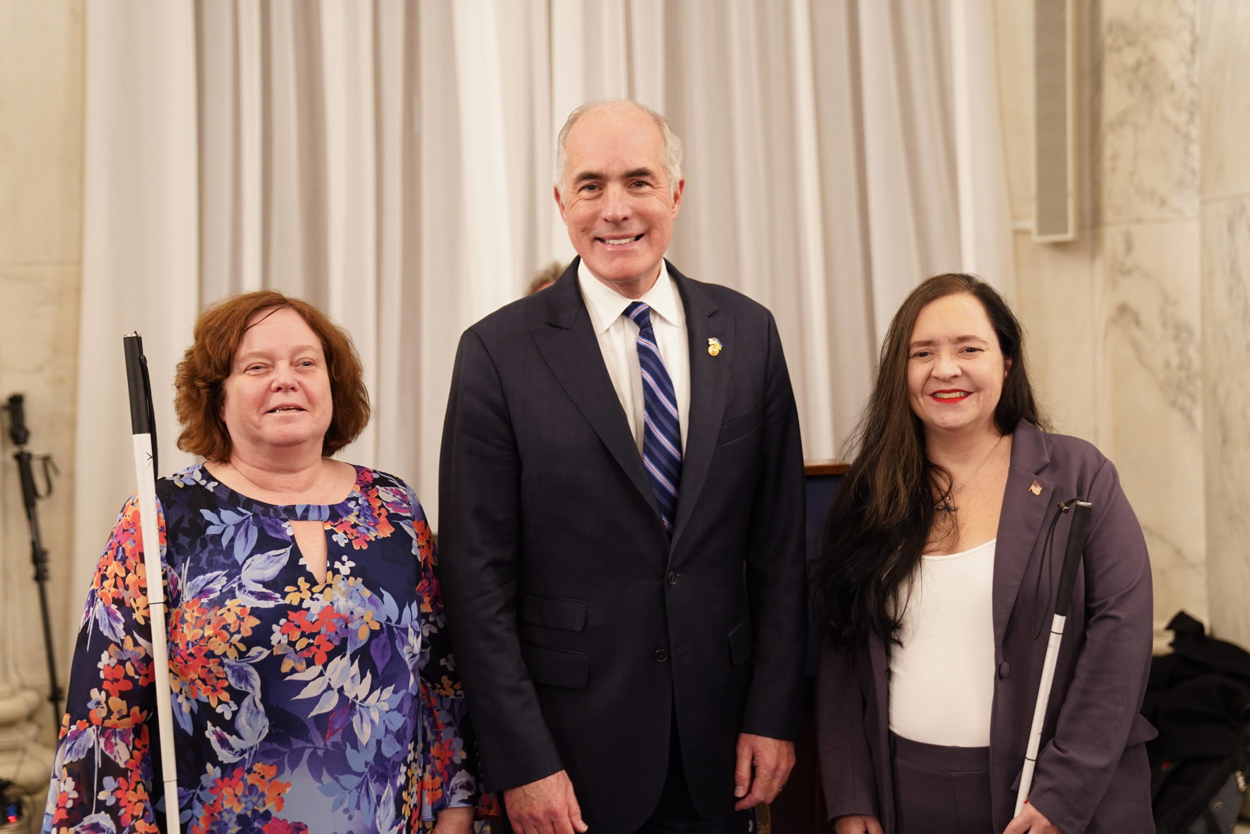 From left to right, NFB of PA President Lynn Heitz, US Senator Bob Casey (D-PA), and NFB of PA Legislative Director Emily Gindlesperger.